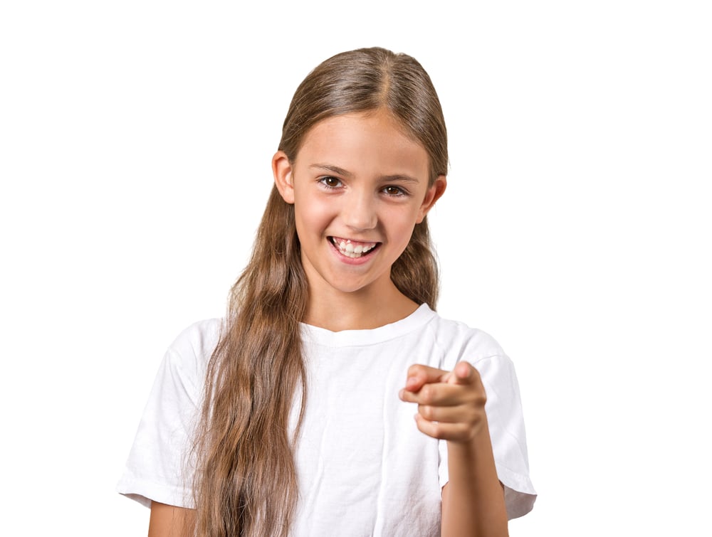 Portrait happy teenager girl pointing finger laughing smiling surprised by something isolated on white background. Positive human emotion facial expression feeling reaction body language Portrait happy teenager girl pointing finger laughing smiling surprised by something isolated on white background. Positive human emotion facial expression feeling reaction body language