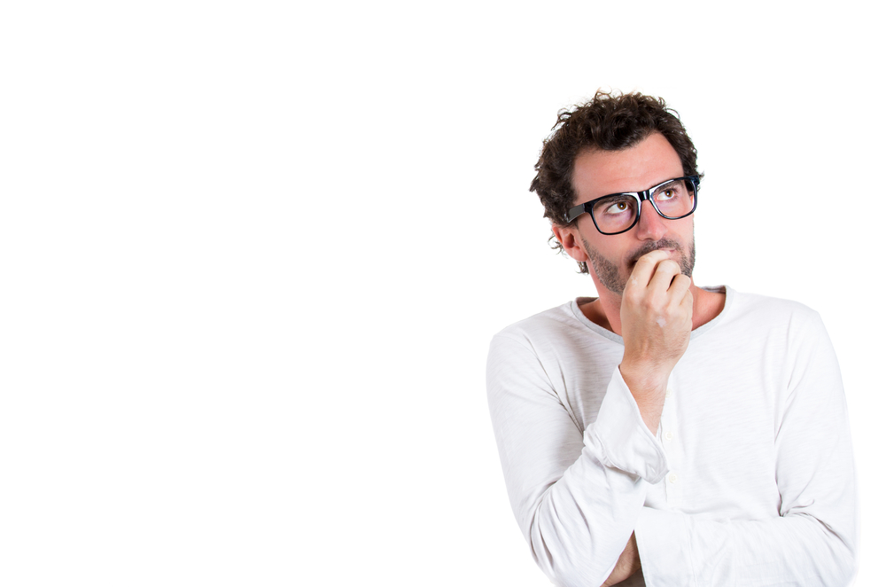 Closeup portrait of handsome young man, wearing black glasses, daydreaming, deep in thought looking up and to side, isolated on white background with copy space. Human emotions and facial expressions Closeup portrait of handsome young man, wearing black glasses, daydreaming, deep in thought looking up and to side, isolated on white background with copy space. Human emotions and facial expressions